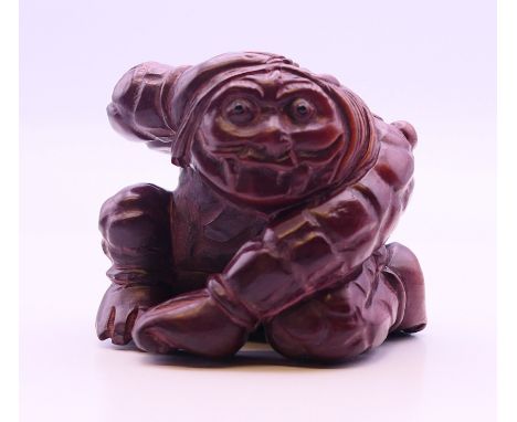 A netsuke formed as a kneeling man.  4 cm high. 