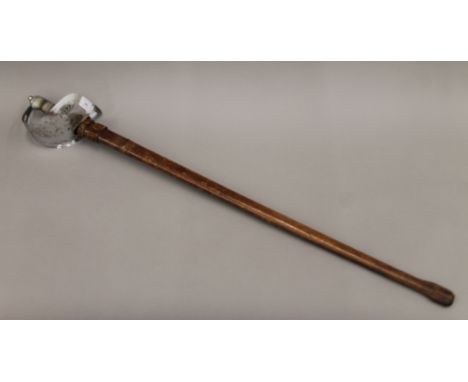 A George V service sword in leather scabbard. 102 cm long.