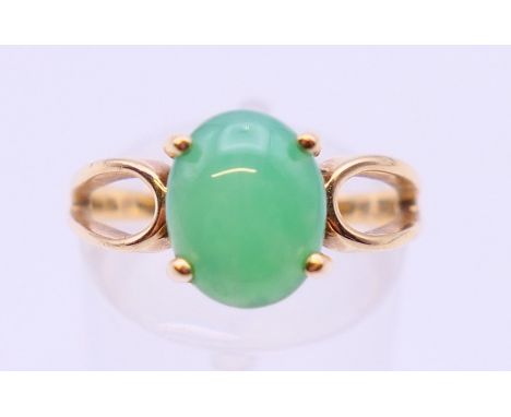 A 14 K gold single stone jade ring. Ring size N/O.  