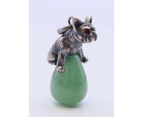 A silver dog on jade pendant.  3 cm high. 