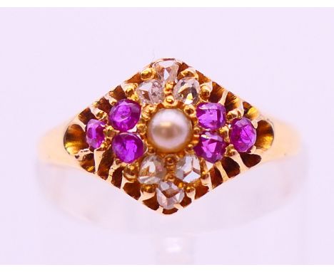 An antique 18 ct gold ruby, diamond and pearl ring, assayed Birmingham 1876. Ring size L.