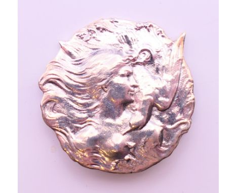 A silver Art Nouveau style female with a dove brooch.  4 cm diameter. 