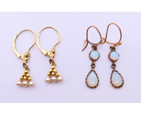 A pair of 14 ct gold and seed pearl drop earrings and a pair of 9 ct gold opal drop earrings.  Seed pearl earrings 1 cm high.