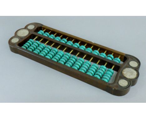 A Chinese coin and turquoise-set wooden abacus. 42 cm long.