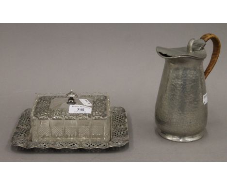 A silver plate mounted butter dish and an Arts and Crafts pewter jug.  The latter 17 cm high.