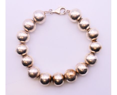 A silver bead bracelet.  18 cm long.