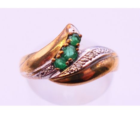 A 9 ct gold diamond and emerald ring. Ring size O.