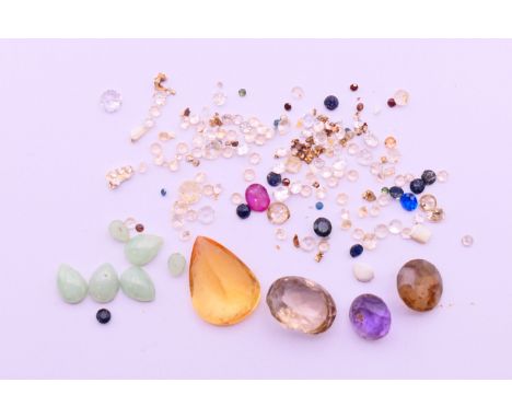 A collection of gemstones, includes diamonds, sapphires, ruby, etc.