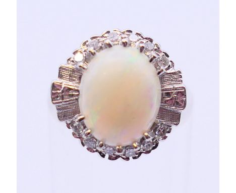 A 14 K white gold, opal and diamond ring. Ring size J/K. 