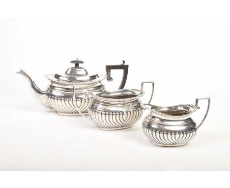 A Victorian silver three piece tea serviceTo include teapot, twin handled sucrier and milk jug all with fluted designs and ap