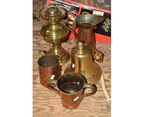 A group of brass and copper items To include twin handled copper and pewter tankard, copper and brass tankard, copper loop ha