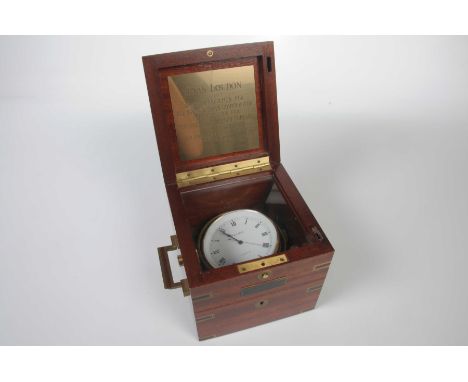 A chronometer form desk clockThe brass bound wooden box with twin handles the hinged cover revealing a clock in the form of a