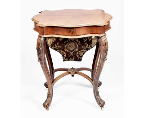 A Victorian rosewood sewing tableHaving a serpentine moulded top above a single frieze drawer and a sliding linen basket, rai