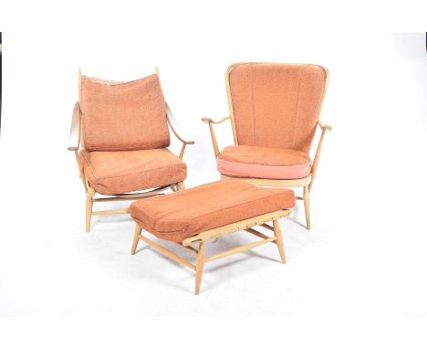 Two Ercol 1960's light beech wood armchairsThe first with a wing back above down swept arms raised upon a turned under frame 