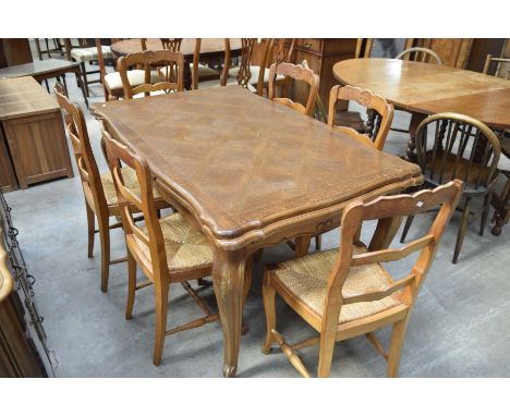 A rustic French style dining room suiteComprising an extending oak dining table with a lattice veneerer top raised upon curvi