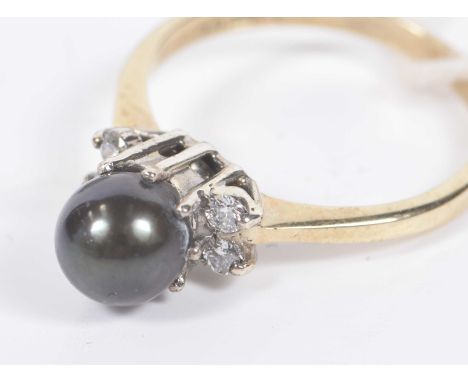 A cultured pearl and diamond ringThe 9K gold shank, with single pearl, flanked by four small diamonds, total weight approx. 2