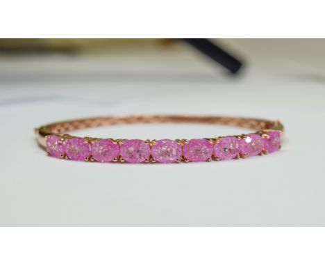 Pink Crackled Quartz Bangle, over 10cts of oval cut, bright pink quartz, the sparkle enhanced by the crackle effect throughou