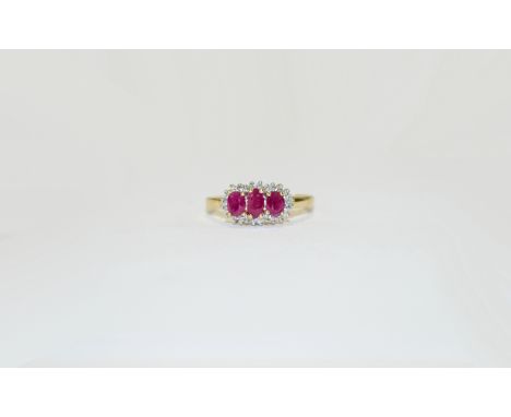 9 ct Diamond and Ruby Cluster Ring. Pretty, raised central setting with 3 oval rubies set amongst small diamonds.