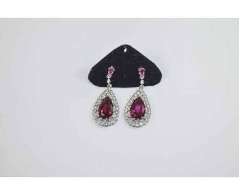 Pair of Faux Ruby and Diamond Drop Earrings, solitaire pear cut Burmese colour faux rubies, framed with bezel set faux diamon