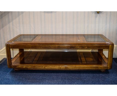 Large Coffee Table Low, rectangular wood coffee table with glass panels to top. Gold banding inlay to top . Bottom shelf deta