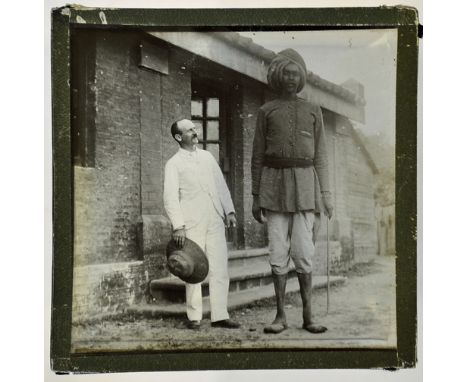 India - A giant from the Punjab glass slide an early 1900s Magic lantern slide depicting a Punjabi giant standing with a Brit