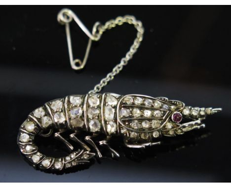 A Rose Cut Diamond and Cabochon Ruby Brooch in the form of a shrimp and in an unmarked precious white metal setting, with saf