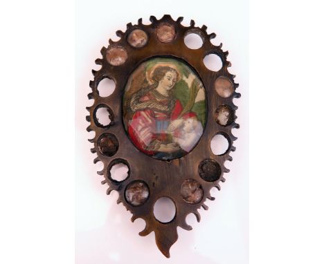 A carved horn reliquary of pear-shaped outline, centered with a polychrome print of mother and child, the reverse with chenil