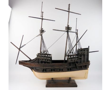 A wooden model of a two mast galleon, with painted hull, eight cannons, partially rigged, 72cm long. 
