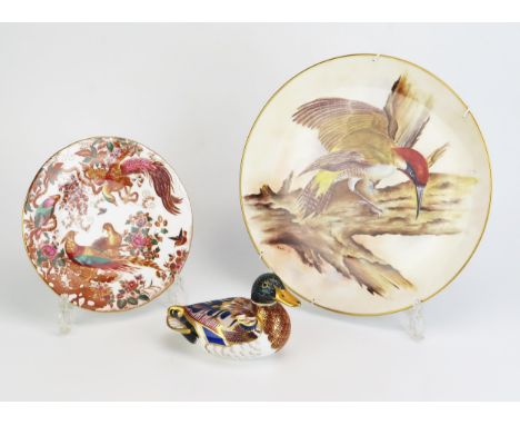 A Bryan Cox Worcester plate decorated with a woodpecker27cm diameter, a Royal Worcester paperweight in the form of a duck, an