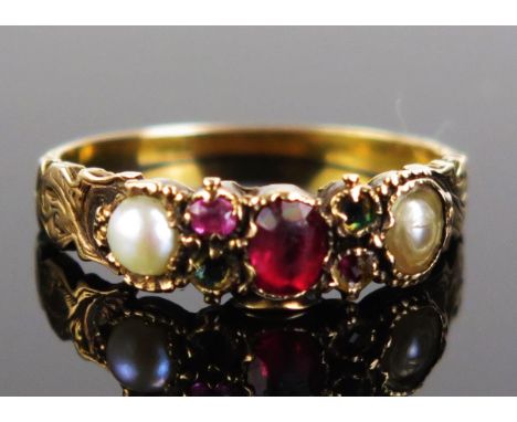 A Victorian untested Pearl and Red Paste Ring with chased decoration and in an unmarked precious yellow metal setting, KEE te