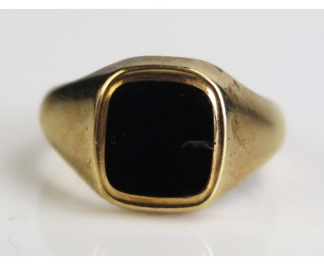 A 9ct Gold and Black Onyx Signet Ring, hallmarked, size S.25, c. 7.78g 