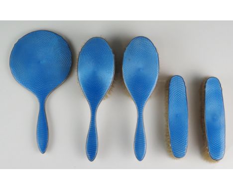 An Edward VIII silver and blue enamel mounted five-piece dressing table set, Birmingham, 1936, includes hand mirror, two hair