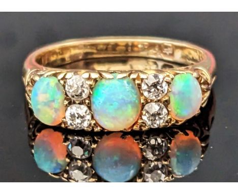 An 18ct Gold, Opal and Diamond Ring, 18mm wide head, hallmarked, size O.25, 4.45g. Marks rubbed, early 20th century 