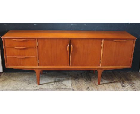 A G-plan teak side board of rectangular outline, having a pair of central cupboard doors flanked by three short drawers and f