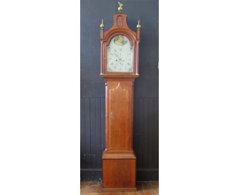 An early 19th century oak longcase clock, the arched hood with ball and spire finials, fluted turned columns, the trunk with 