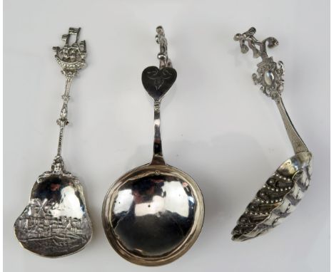 Three Dutch silver caddy spoons, with various shaped bowls, with figural and boat terminals, total weight of silver 62gms, 1.