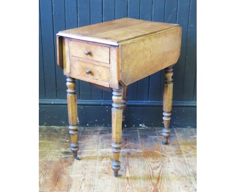 A Victorian walnut sewing table, the top with two hinged leaves, with two short drawers and side to one end and cupboard door