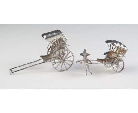 A miniature silver model of a rickshaw, 7cm long, together with a smaller similar model 6cm long, 35gms, 1.15ozs 