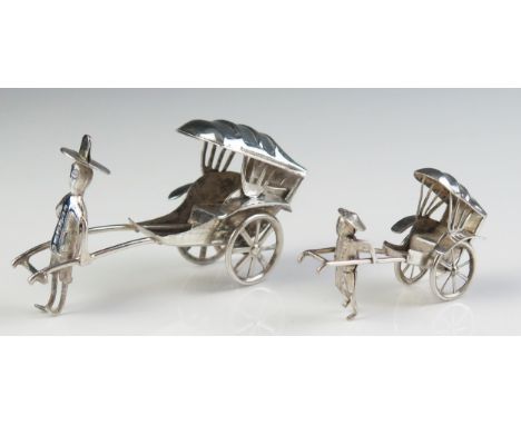 A miniature silver model of a rickshaw, 7cm long, together with a smaller similar model 5cm long, 30gms, 0.96ozs 