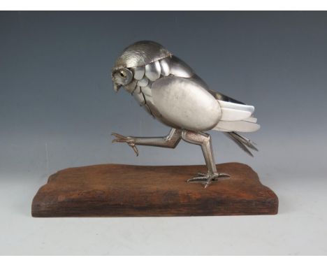 Alan Prince, a modernist metal model of a strutting owl, made from assorted spoons, knife blades and handles. mounted on a re