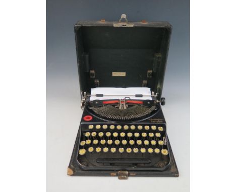 A Remington portable typewriter, contained in its fitted carrying case. 