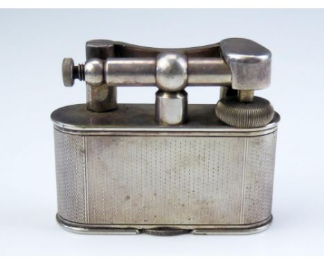 Dunhill, a plated table lighter, design No 737418, with engine turned decoration, 8cm long, 