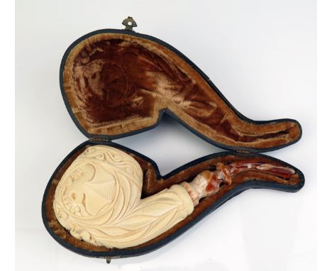 An unused Yunar carved Meerschaum pipe, the bowl decorated with winged dragons, flowerhead and foliage, with curved mouthpiec