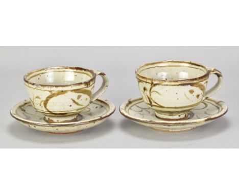 RUPERT SPIRA (born 1960); an early pair of stoneware cups and saucers covered in pale grey glaze with iron decoration, impres