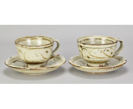 RUPERT SPIRA (born 1960); an early pair of stoneware cups and saucers covered in pale grey glaze with iron decoration, impres