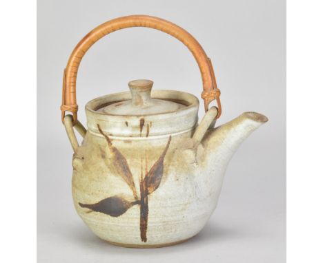 A stoneware teapot with cane handle covered in grey glaze with iron decoration, painted AM mark, height 14.5cm (excluding han