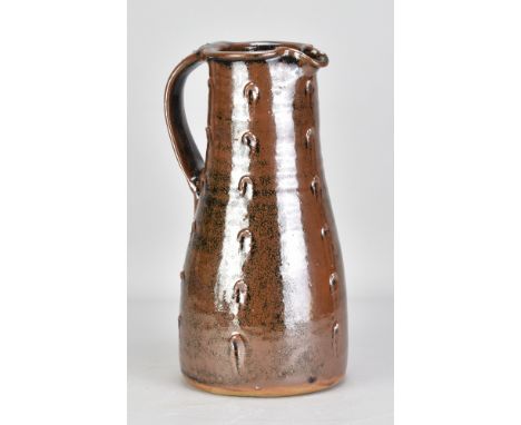 JIM MALONE (born 1946); a stoneware pitcher covered in tenmoku breaking to kaki glaze with impressed decoration, impressed JM