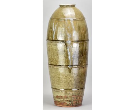 JIM MALONE (born 1946); a very tall ribbed stoneware bottle covered in green ash glaze with nuka pours, impressed JM and L (f