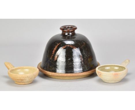 MARTHA ALLEN (born 1952); a stoneware cheese dome and plate covered in tenmoku breakling to kaki glaze with wax resist decora
