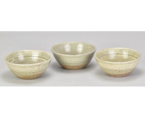 RICHARD BATTERHAM (1936-2021); a set of three small stoneware bowls partially covered in green ash glaze, largest diameter 13